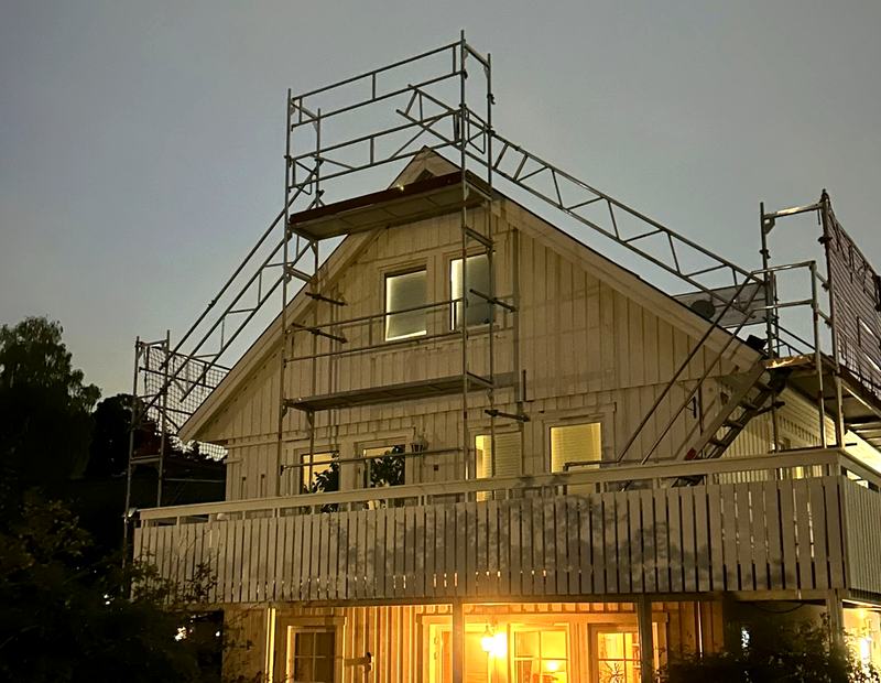 Gavelställning med trapptorn på en vit villa i kvällsljus